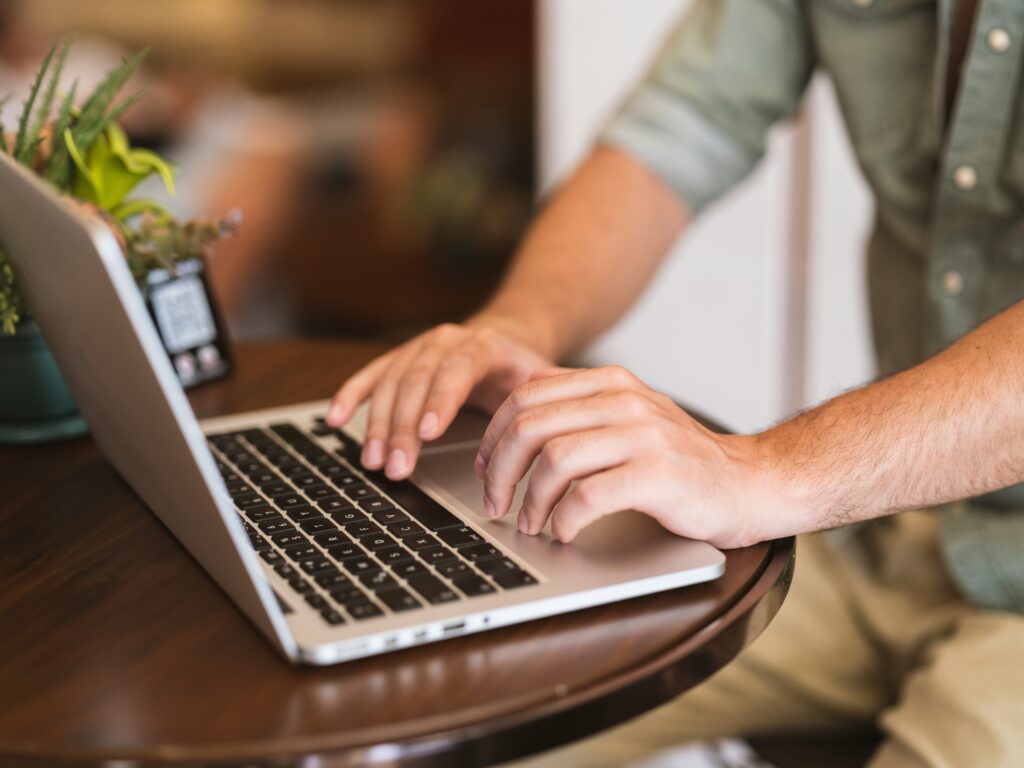 A person using a laptop, completing the process of applying for disability benefits.
