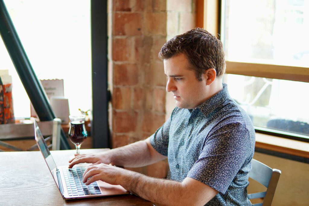 A man using a laptop, researching the need for Social Security Disability reform.