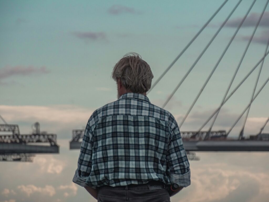 An elderly man looking at the clouds, reflecting on the relationship between Social Security Disability payments and pension benefits.