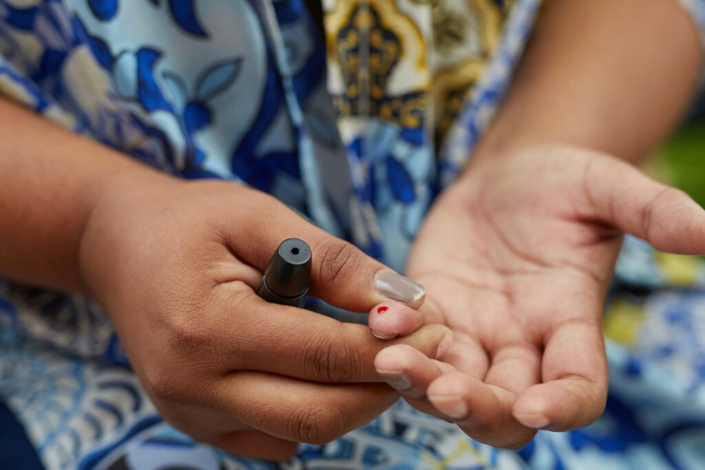 A person testing their blood sugar, illustrating Social Security Disability considerations for Type 1 or Type 2 diabetes sufferers.