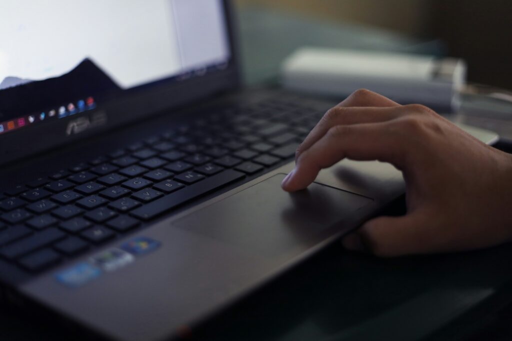 A person using a laptop, learning the basics of Social Security Disability Insurance (SSDI).