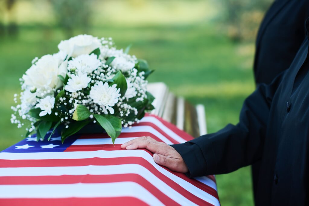 service for a veteran, showcasing a dignified atmosphere with flowers and an American flag present.