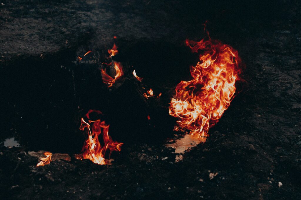 A burn pit emitting smoke, highlighting the link between burn pit exposure and lung disease.
