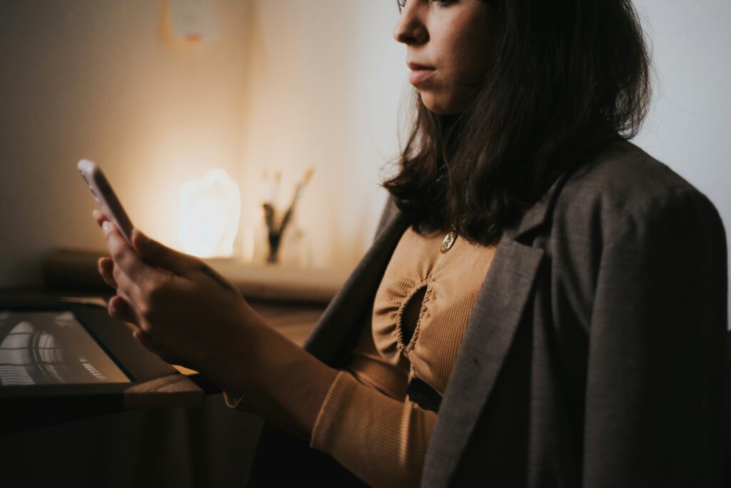 A woman using a phone to learn how to qualify as disabled according to the Social Security Administration.