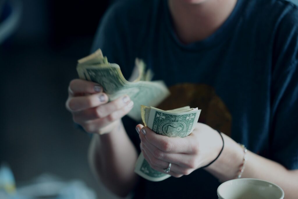 A person counting cash, illustrating the asset limits for Supplemental Security Income (SSI) recipients.