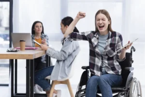 A woman in a wheelchair is happily celebrating, representing the uplifting effects of SSDI benefits for California recipients
