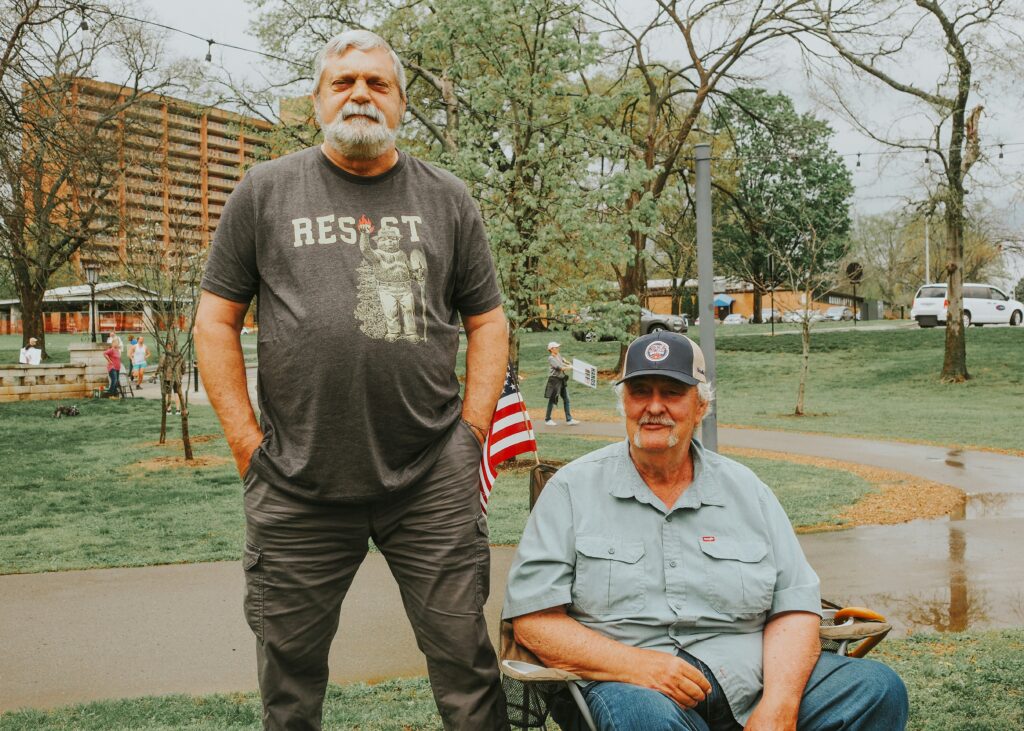 Two U.S. veterans, one standing and one in a wheelchair, representing SSDI benefits and legal support for disabled veterans in California.