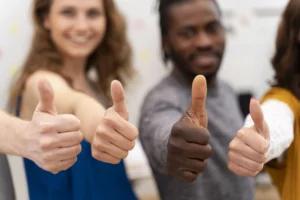Four people giving a thumbs-up, symbolizing the benefits of hiring a Social Security Disability attorney for SSDI success in California.